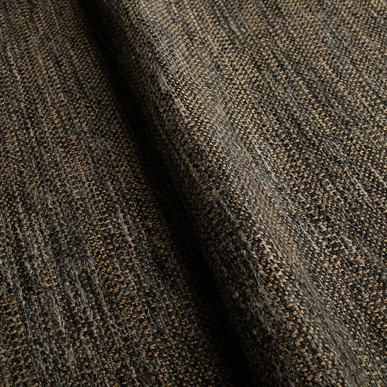 Close-up of textured brown fabric with a herringbone pattern
