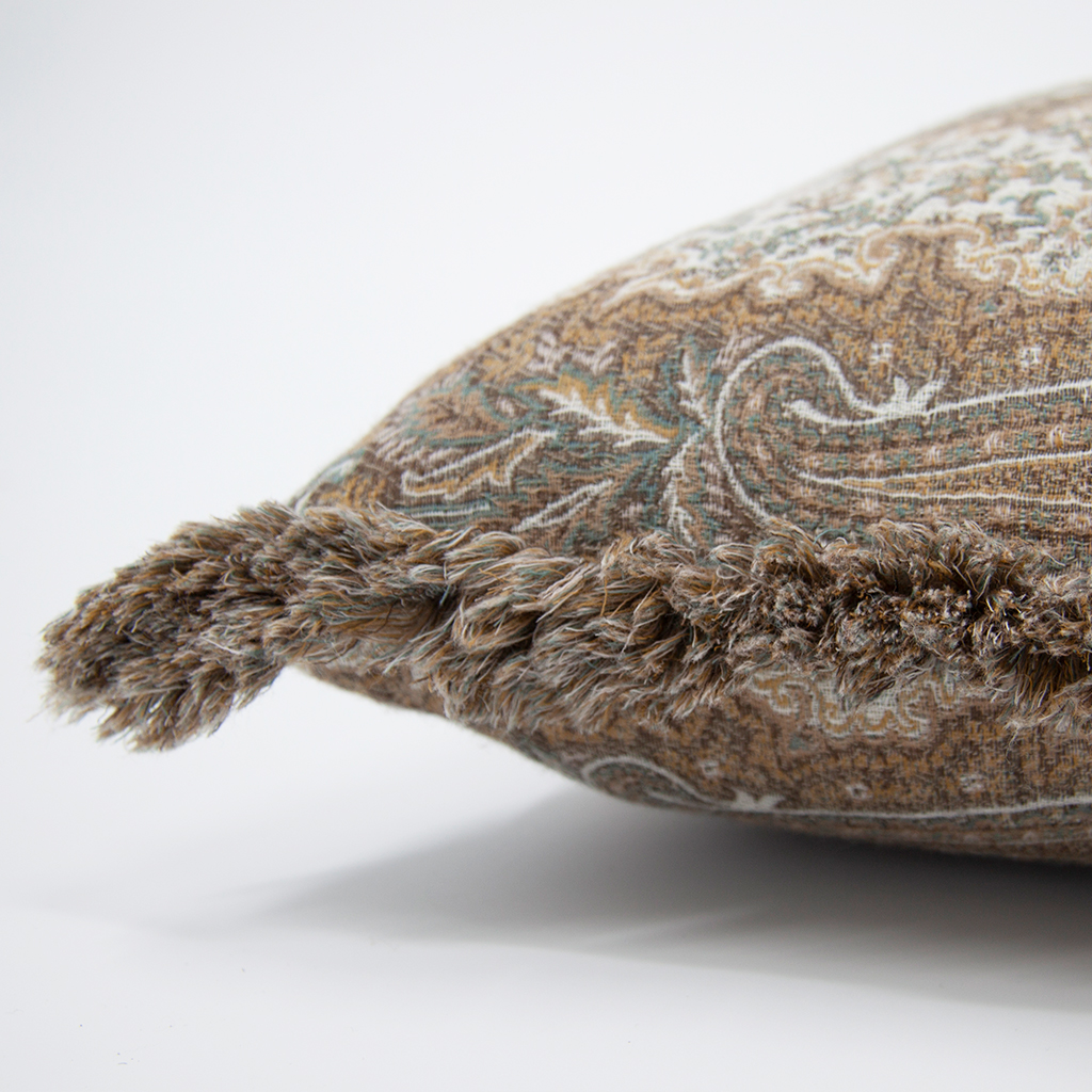Close-up of a decorative pillow with intricate patterns on a white background